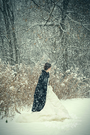 Young Woman Wearing a White Dress in a Forest with Snow
