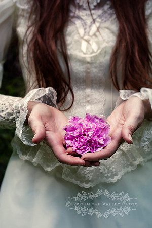 Woman Holding a Purple Flower