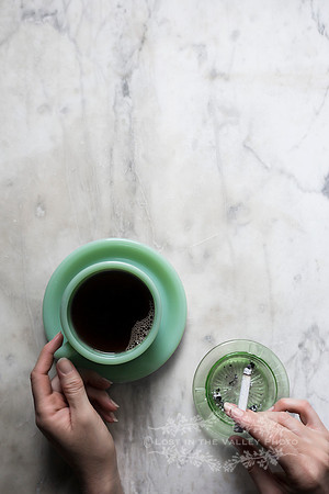 Woman's Hands Holding a Cigarette and Coffee Cup