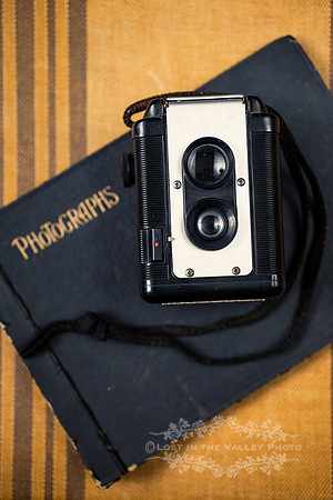 Vintage Camera on Top of a Photo Album