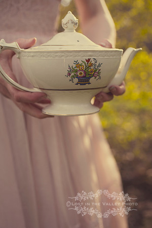 Woman Wearing a Pink Dress Holding a Teapot