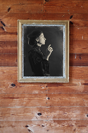 A Photograph of a Woman Against a Wooden Background